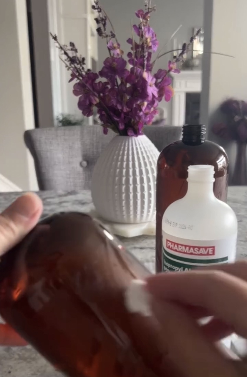 close up image of cotton ball removing glue residue with rubbing alcohol 