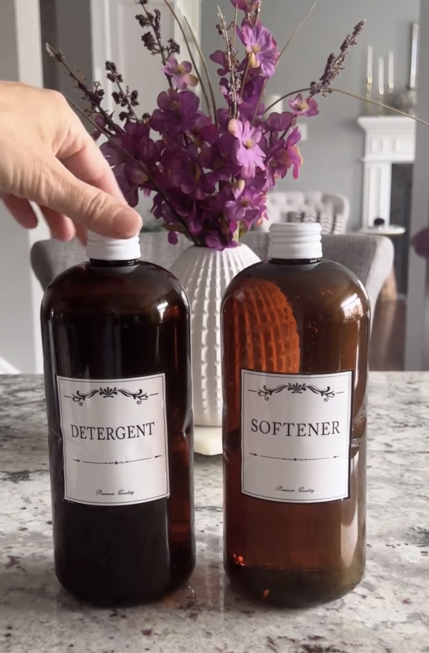 closeup image of white twist on caps being put on brown bottles