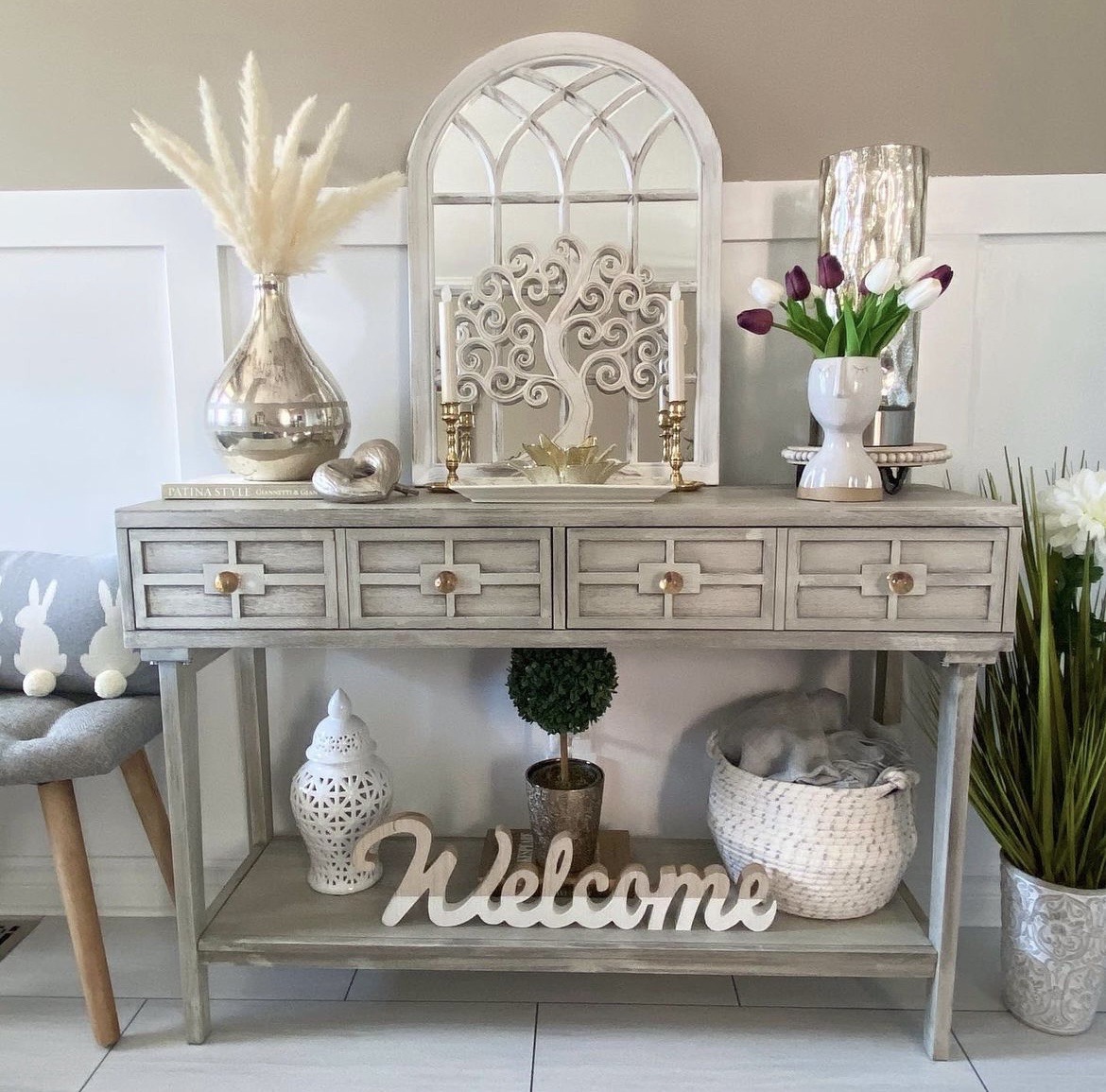 reveal image 2 of DIY front entryway ideas showing table with decor and grey stool