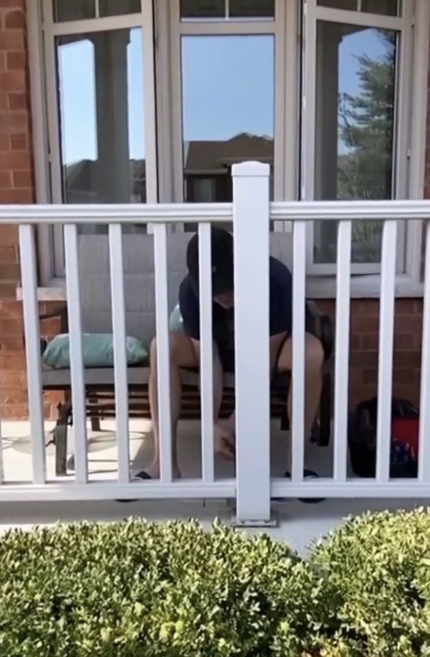 image of man loosening base of railing