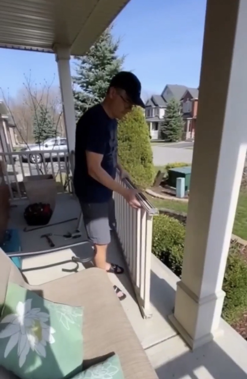 image of man carrying away railing pieces