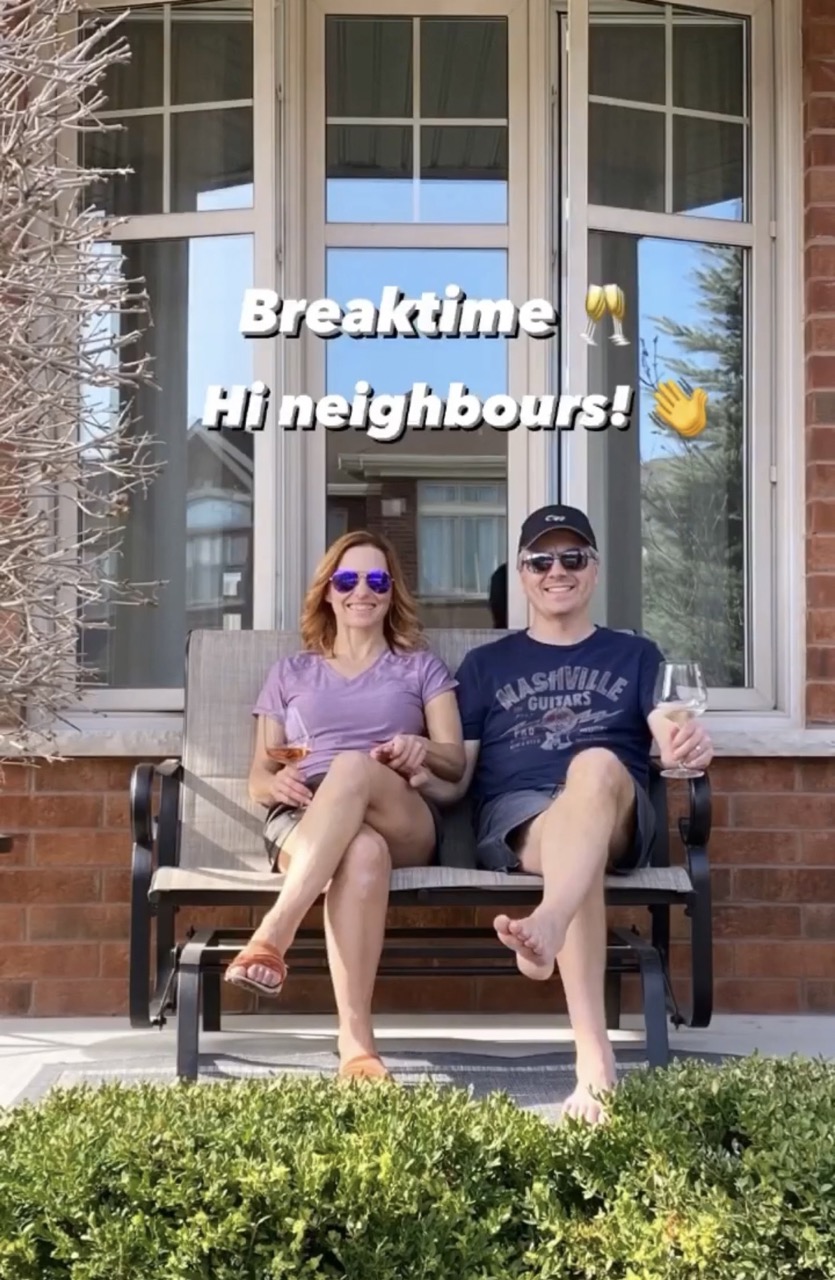 image of man and woman enjoying a drink on the porch glider