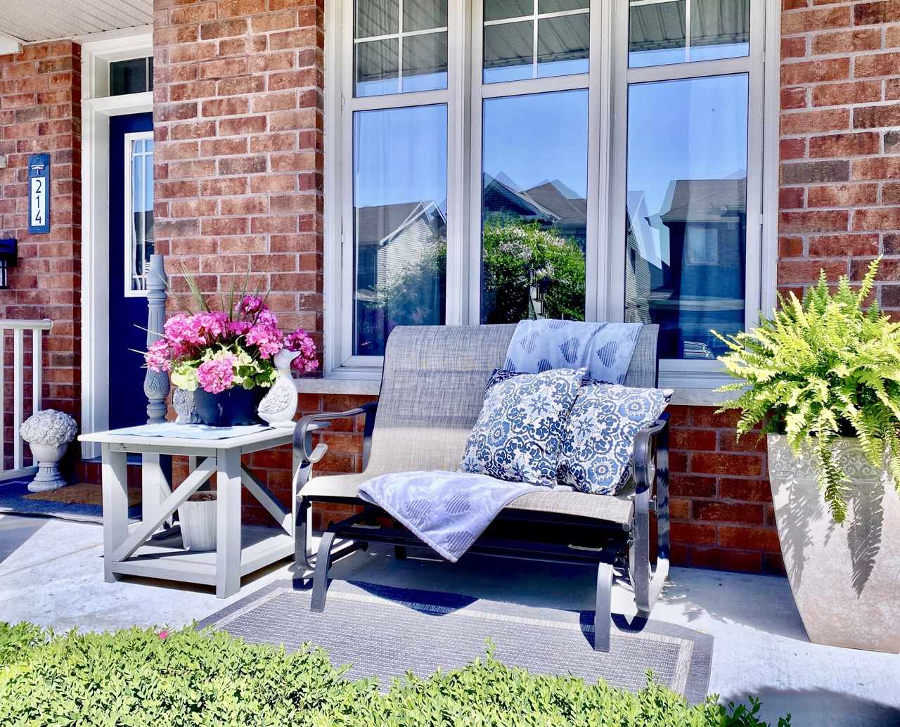 reveal image of porch with glider and small outdoor diy table