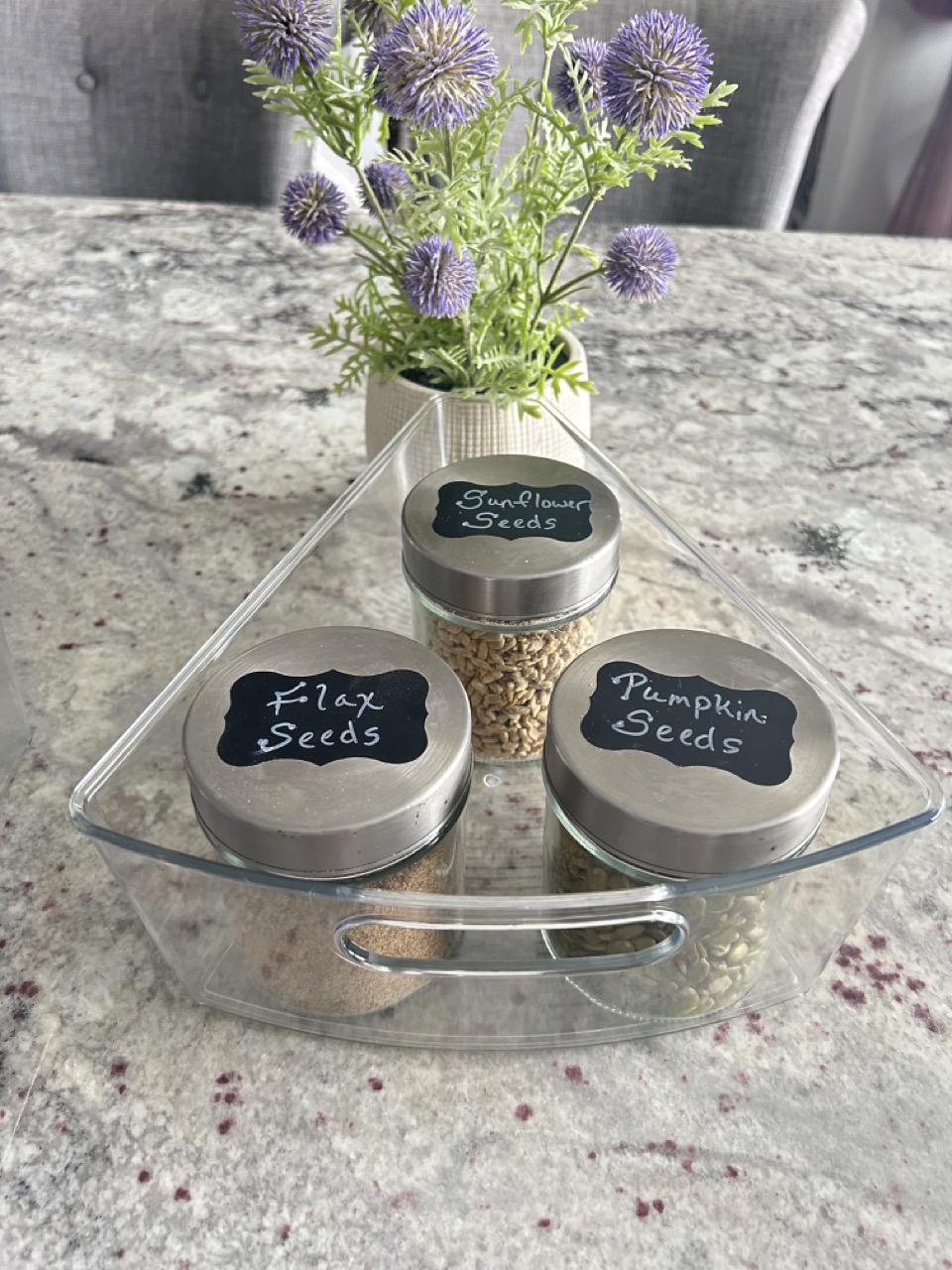 image of a corner cupboard wedge bin with jars of nuts and seeds