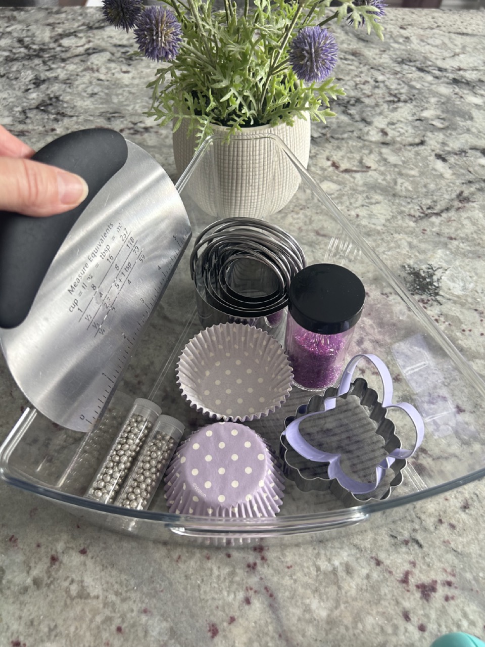 image of a kitchen wedge bin with dough cutter and cookie sprinkles in dollar store jars