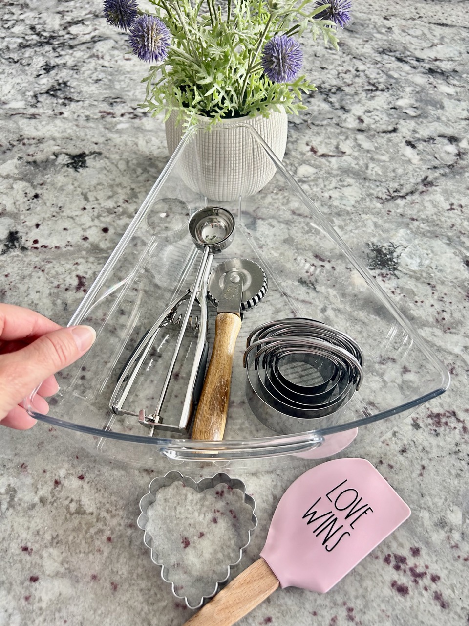 image of a kitchen corner cabinet wedge bin with spatula and cookie cutter