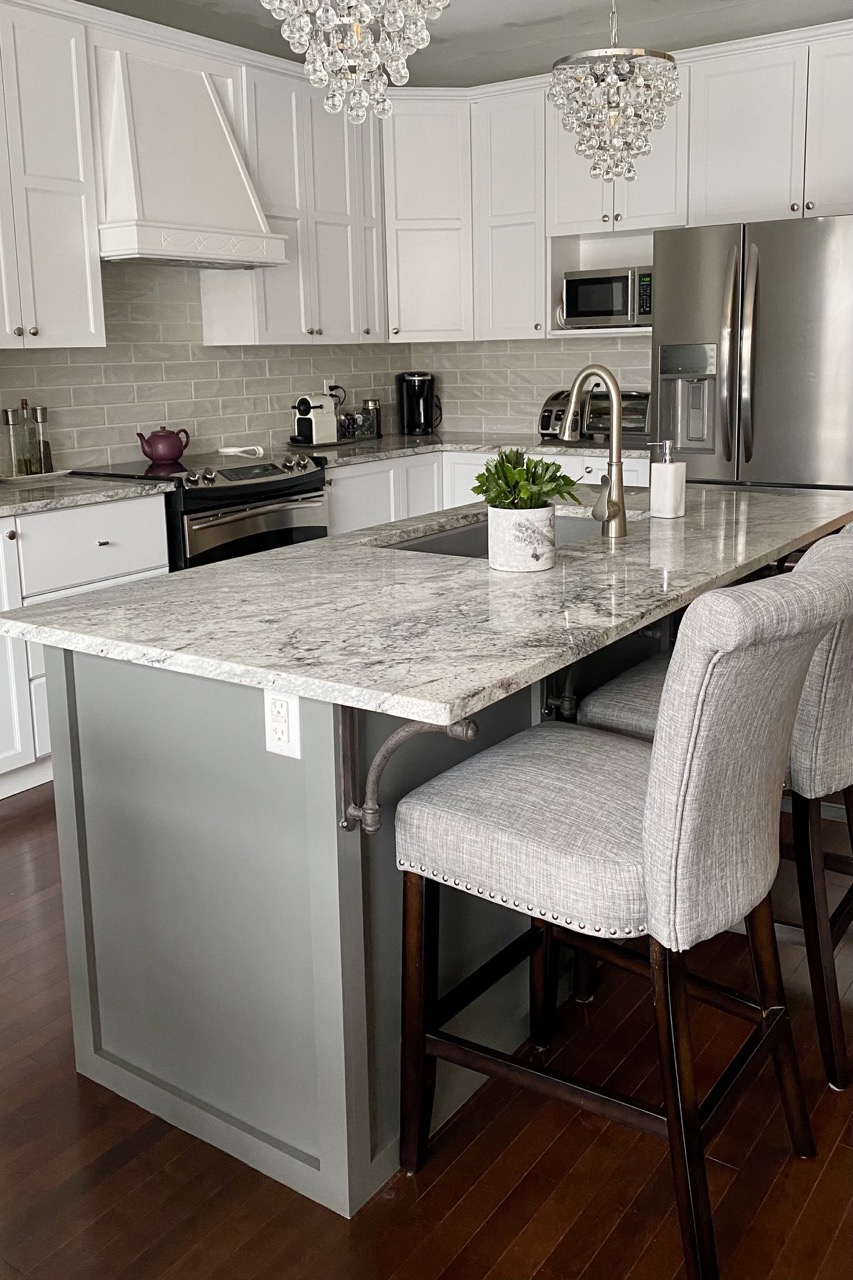 image of kitchen island white cabinets and crystal pendants