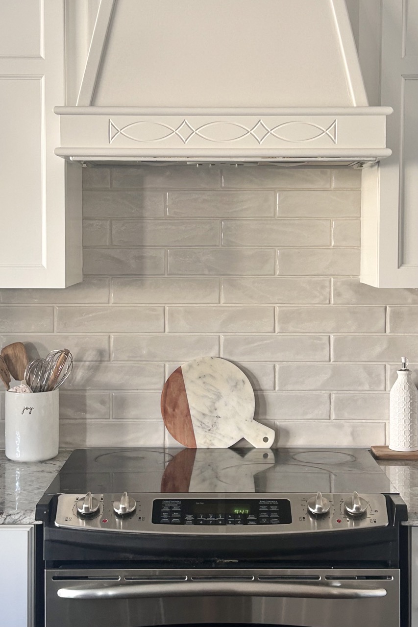 closeup image of new light grey subway backsplash tile in kitchen makeover
