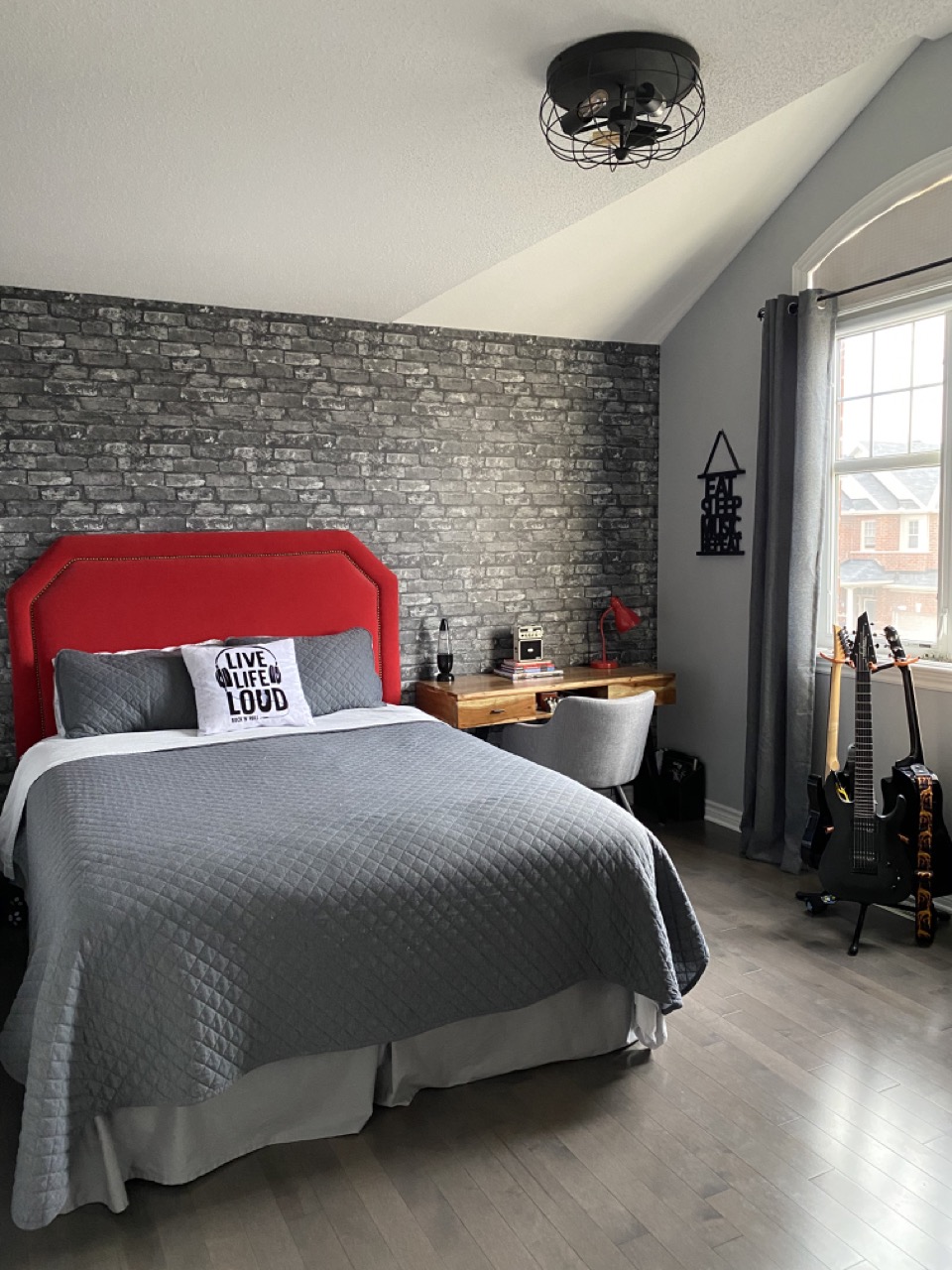 reveal image of teen bedroom makeover showing bed, headboard desk and guitars