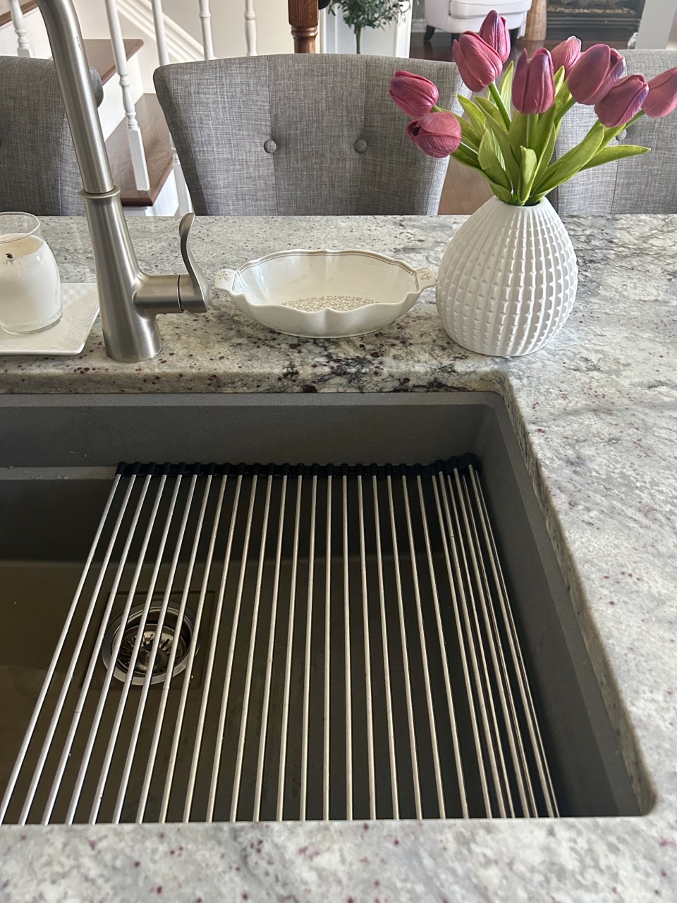 closeup image of roll up kitchen dish rack on the inside edge of sink