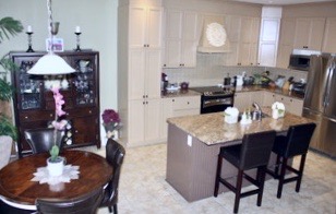image of old kitchen before reno cabinets painted in caramel colour