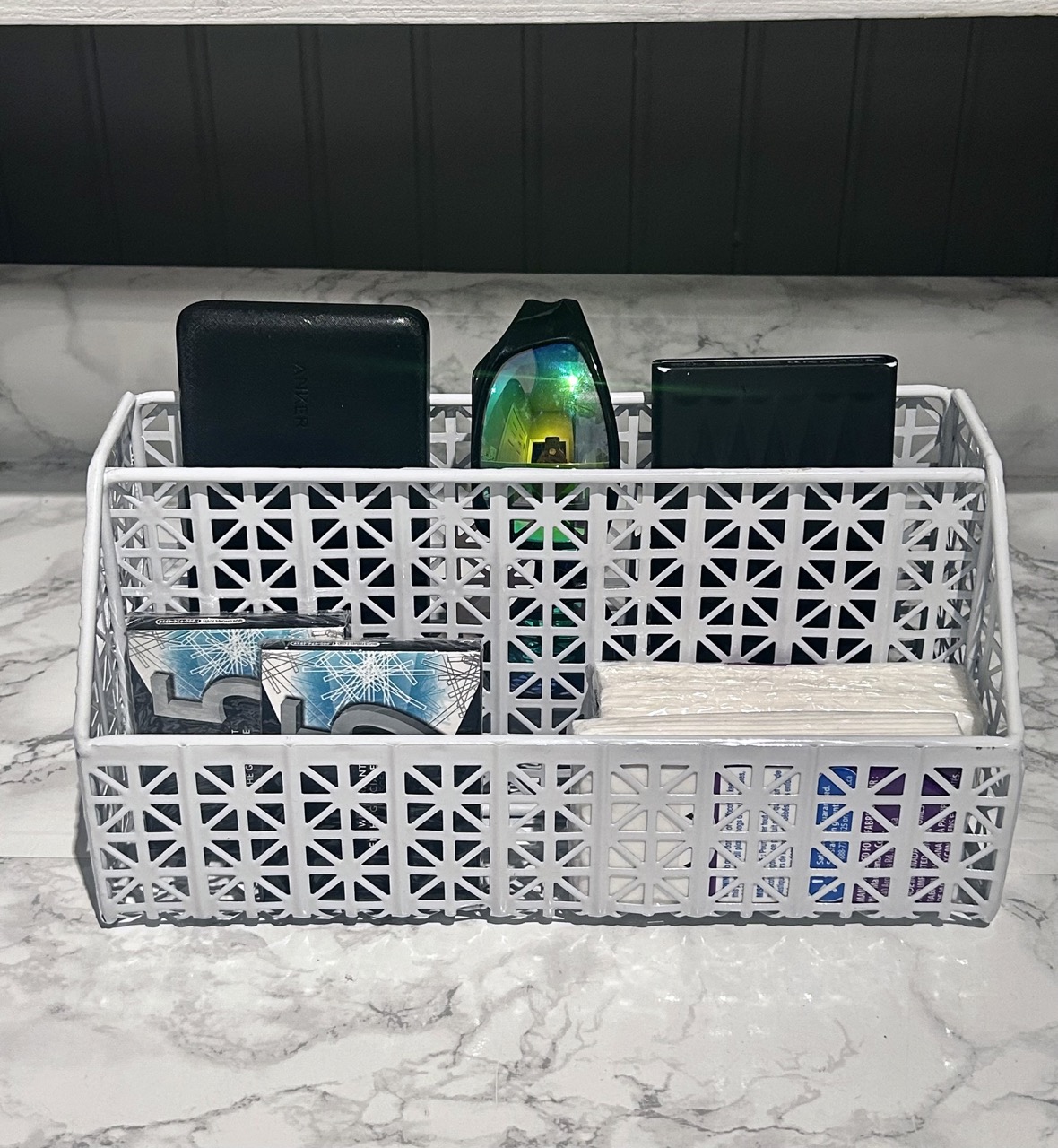 image of desk organizer filled with iphones gum and kleenex