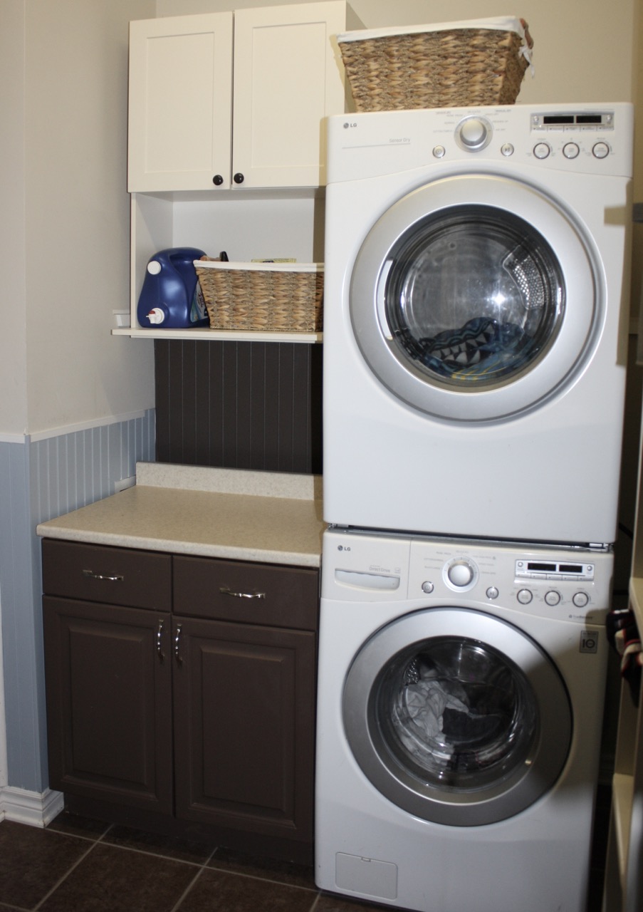 laundry room makeover progress showing new cabinet before painting