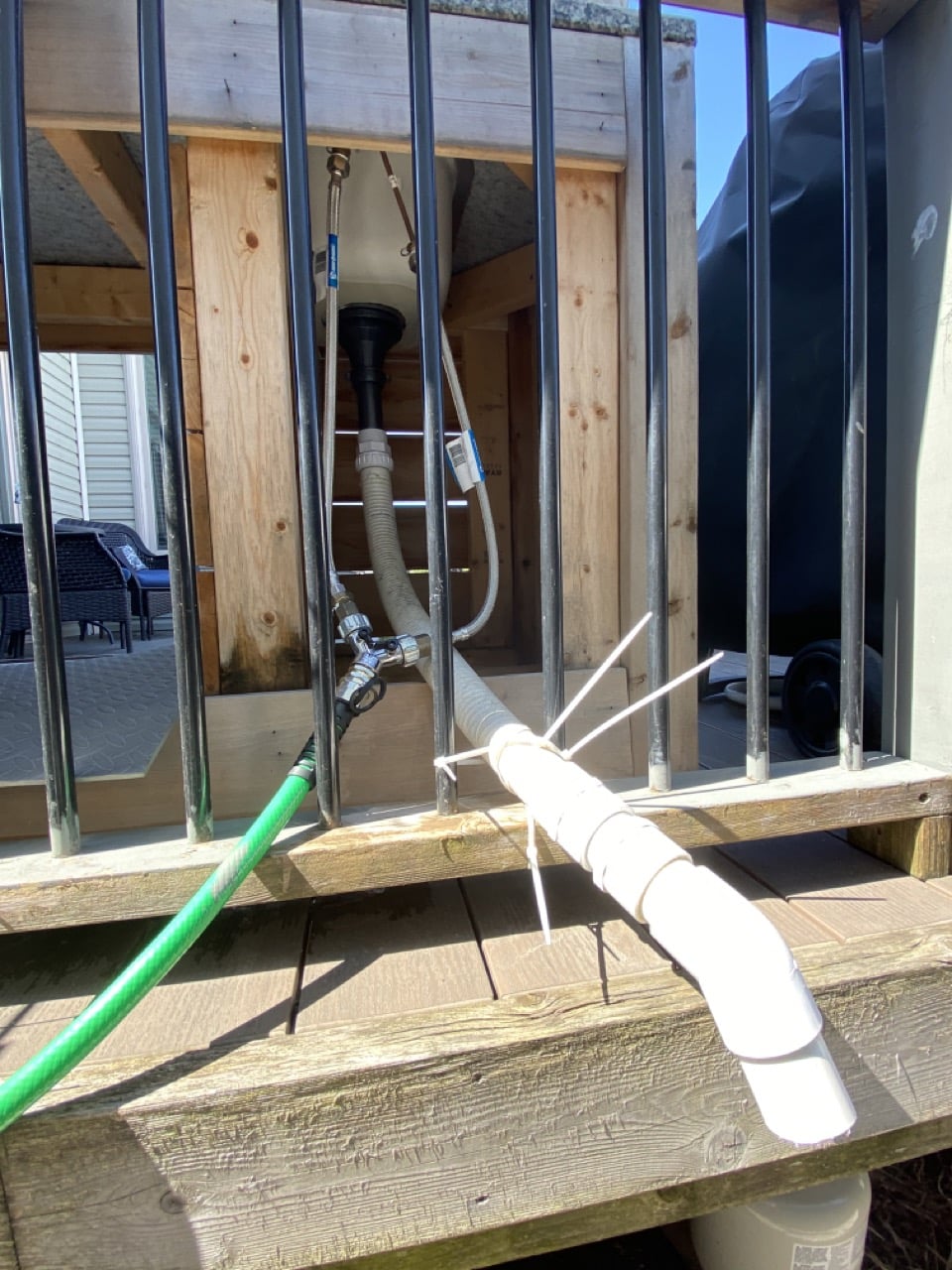 image of outdoor kitchen plumbing showing hose and drain pipe