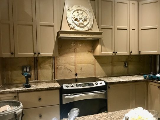 image of kitchen backsplash area with drywall and old tile removed